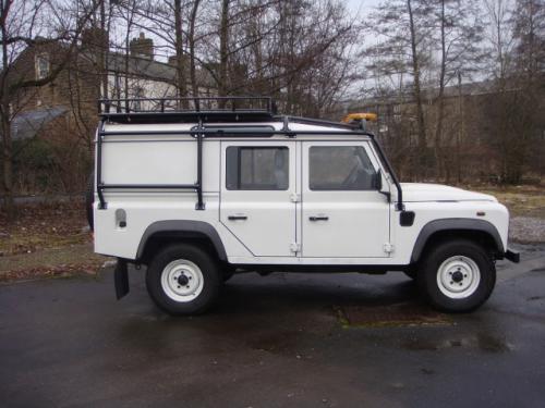 LWB Defender with full external roll cage and roof rack